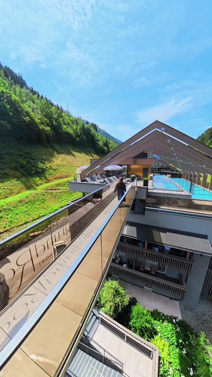 FPV drone in flight alongside a hotel in the mountains